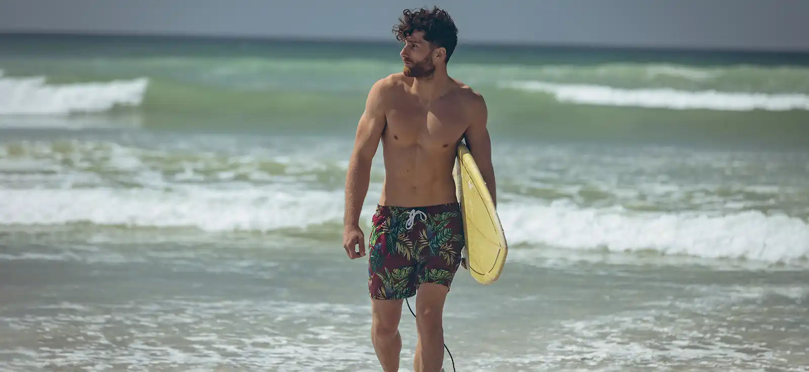 Shirtless man with surfboard.